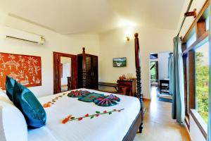 Ένα ή περισσότερα κρεβάτια σε δωμάτιο στο Heritage Resort Coorg +88 φωτογραφίες