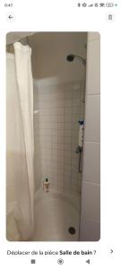 a bathroom with a shower with a shower curtain at appartement proche zenith in Montpellier +8 photos
