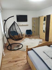 a bedroom with a net basket on the floor at Márti Apartman in Sátoraljaújhely
