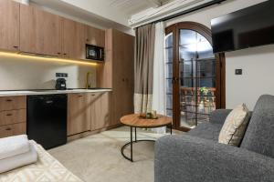 a kitchen and living room with a couch and a table at Sea View Center 2 in Limenas +22 photos