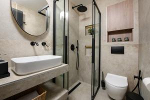 a bathroom with a shower and a sink and a toilet at Sea View Center 2 in Limenas