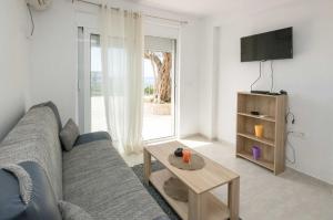 a living room with a couch and a table at Apartments San with Sea View in Dobra Voda