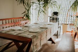 a wooden table with bowls and plates on it at Willa Murena in Mielno