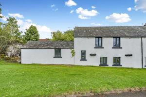 a white house with a green yard at 2 Bed in Troutbeck oc-b32579 in Troutbeck
