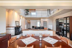 a dining room and living room with a table and chairs at Paula Cozy Villa in Corfu in Áfra