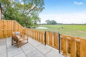 a patio with a wooden fence and a bench at 1 Bed in Marishes oc-l32536 in Kirby Misperton