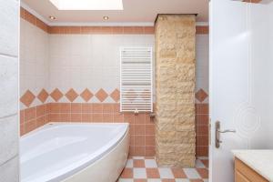 a bathroom with a tub and a tile floor at Paula Cozy Villa in Corfu in Áfra +36 photos