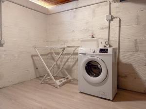 a washing machine in a room with a wall at Relax & Views in Le Marche by Host Hero in Morrovalle