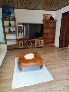 un soggiorno con un tavolo e una TV di Alambic de Grand Anse a Petite-Île Altre 12 foto
