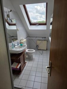 a bathroom with a sink toilet and a window at Apart Konkordia in Chemnitz +18 photos
