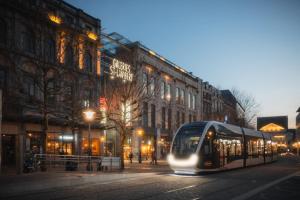 a bus driving down a city street at night at 302 Le Spot Neuvice in Liège