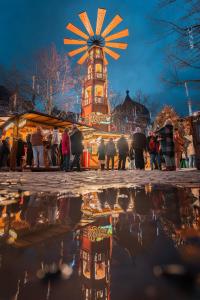 a reflection of a clock tower in a puddle of water at 302 Le Spot Neuvice in Liège