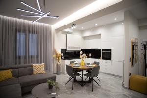 a living room with a table and a couch at Kastrino Luxury Apartment in Ioannina +19 photos