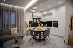 a kitchen and living room with a table and chairs at Kastrino Luxury Apartment in Ioannina