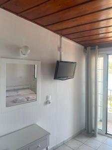 A television and/or entertainment centre at Agnàntema Portside Stays Skiathos