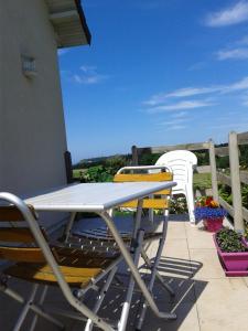 a table and chairs on a patio with a view at Chez Sylvia et Patrice in Saint-Léonard