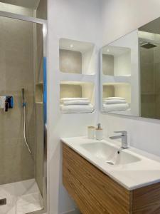 a bathroom with a sink and a shower at Elis rooms & suite in Olbia