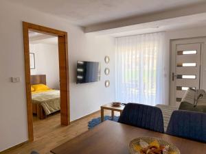 a living room with a couch and a bed and a mirror at TaNa's Villa in Donji Štoj