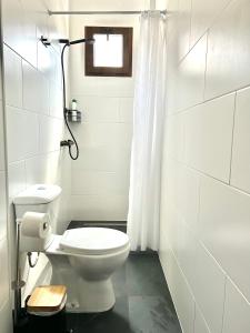 a white bathroom with a toilet and a window at CENTER APARTMENT Mazagón in Mazagón +17 photos