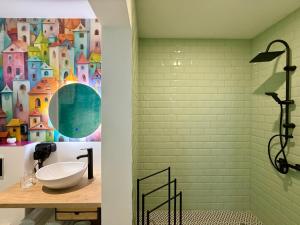a bathroom with a sink and a wall mural at Eclectic 6 in Satu Mare +53 photos