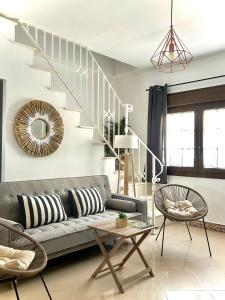 a living room with a couch and a staircase at CENTER APARTMENT Mazagón in Mazagón