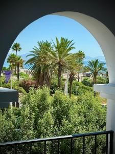 a view of palm trees from a balcony at VVVHouse in Manilva