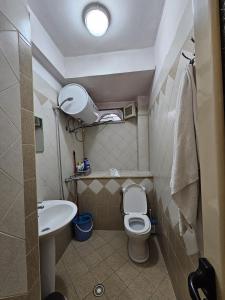 a small bathroom with a toilet and a sink at Saranda Garden Rooms in Sarandë +20 photos