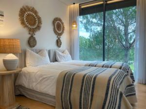 a bedroom with a bed and a large window at Summer Villa in Troia