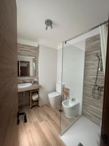 a bathroom with a shower and a sink and a toilet at Bahamas Avenida Muelle in Puerto de la Cruz