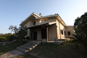 a white house with stairs in front of it at Agriturismo Pietragrande in Otranto
