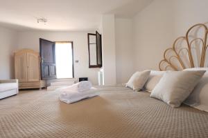 a bedroom with a large bed with two towels on it at Agriturismo Pietragrande in Otranto
