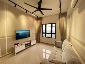 a living room with a couch and a flat screen tv at Central Park Damansara Near KPJ, 1Utama, The Curve by The Homez in Petaling Jaya