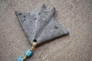 a piece of metal with a blue bead on it at Casa da Baía - Guest House in Horta