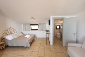 a bedroom with a bed and a bathroom at Agriturismo Pietragrande in Otranto