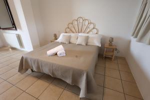 a bedroom with a bed with two towels on it at Agriturismo Pietragrande in Otranto +54 photos