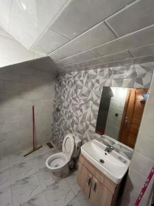 a bathroom with a toilet and a sink at Bouznika mandarona in Bouznika