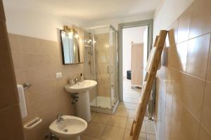 a bathroom with a sink and a toilet and a shower at Agriturismo Pietragrande in Otranto +45 photos