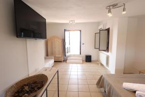 a living room with a television on a wall at Agriturismo Pietragrande in Otranto