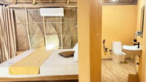 a bedroom with a bed and a toilet in a room at Royal beach in Pottuvil