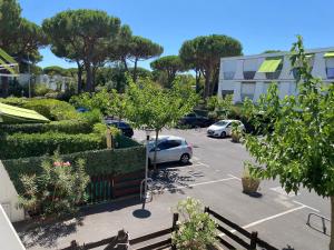 a parking lot with a car parked in it at Échappée Bohème & Lumière in La Grande-Motte