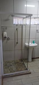 a shower in a bathroom with a toilet and a sink at Olive rest in Wesselsbron