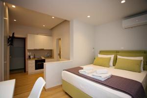 a bedroom with a large bed with towels on it at Emily in Athens - Central balconette flat with Starlink in Athens