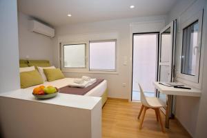 a bedroom with a bed and a bowl of fruit on a table at Emily in Athens - Central balconette flat with Starlink in Athens