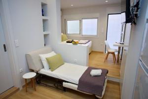 a small room with a bed and a table at Emily in Athens - Central balconette flat with Starlink in Athens