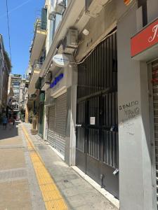 an empty street in a city with a building at Emily in Athens - Central balconette flat with Starlink in Athens