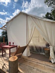 a tent with a chair and a table at La casetta delle stelle - relax e riservatezza a 550m di quota in Langhirano