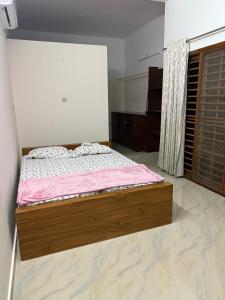 a bedroom with a bed in a room at Bindas in Trivandrum +38 photos
