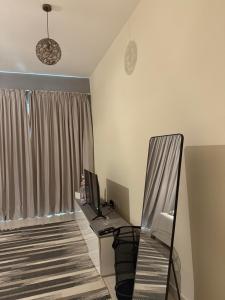 a room with a desk with a computer and a chair at One Click in Dubai