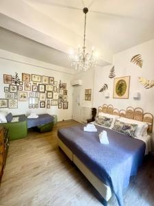 a bedroom with two beds and a chandelier at L'8 Boutique Concept Apartments in Bologna