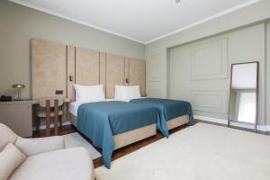 Postel nebo postele na pokoji v ubytování Hotel Majestic